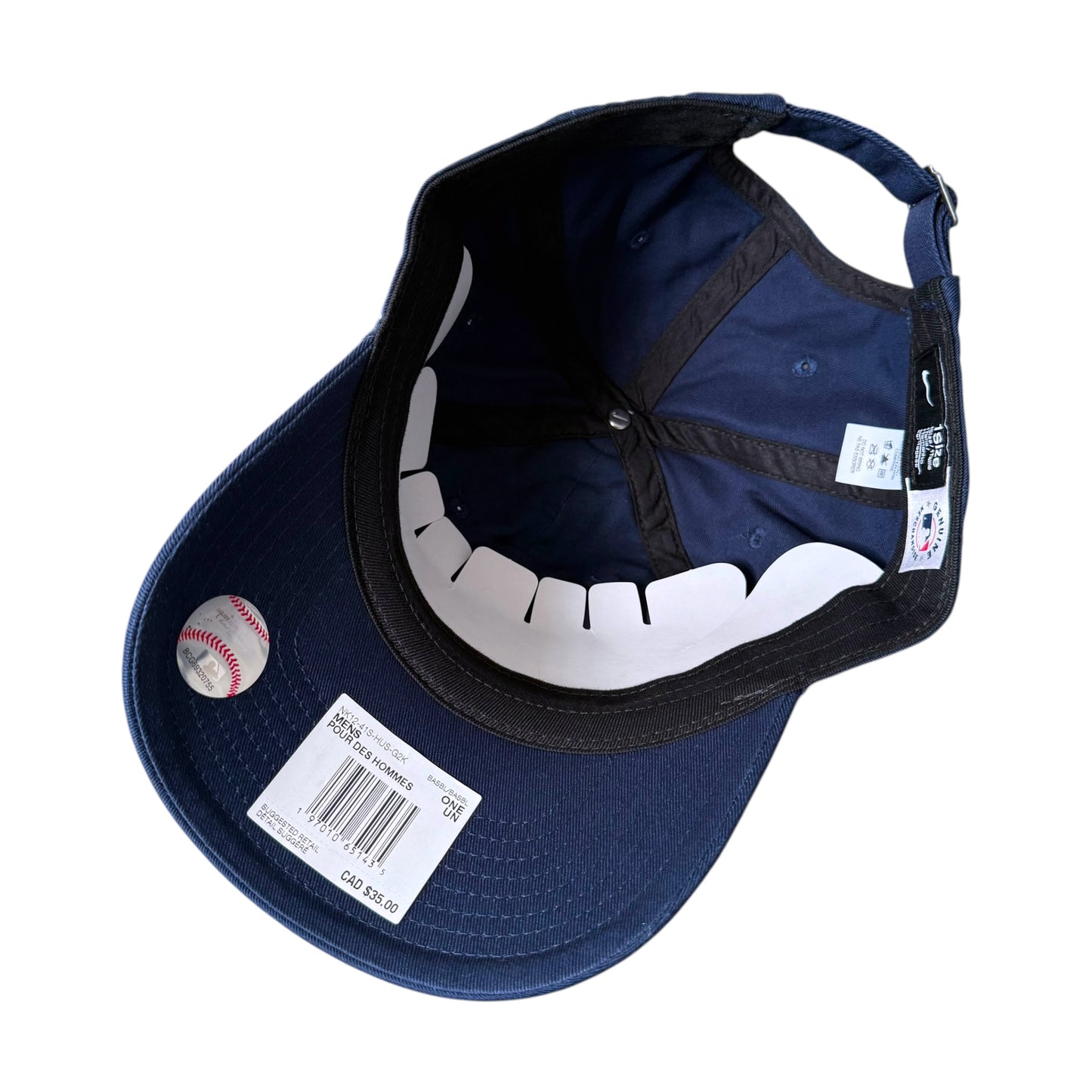 A navy blue baseball cap shown from an overhead angle on a white background. A baseball sticker is attached to the brim, and retail tags are visible.