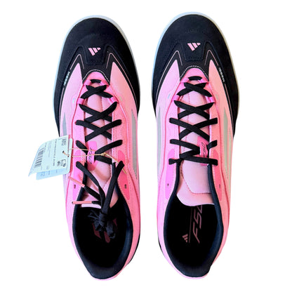 A pair of Adidas F50 soccer cleats in pink and black, shown from a top-down view on a white background with a product tag attached to the left shoe.