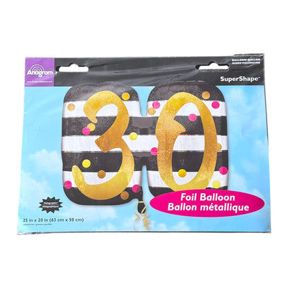 A packaged foil balloon set shaped like the number 30, with black and white stripes, gold foil lettering, and pink and gold confetti dots. The product is shown in its retail packaging with a blue sky background and branding for Anagram and SuperShape.