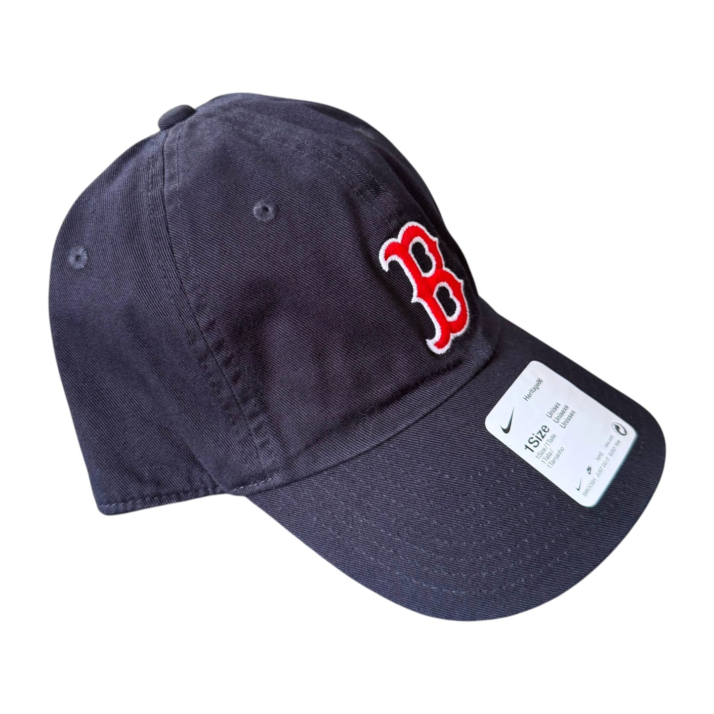 A navy blue baseball cap featuring the red and white Boston Red Sox 'B' logo on the front and a white Nike size tag on the brim, set against a plain white background.