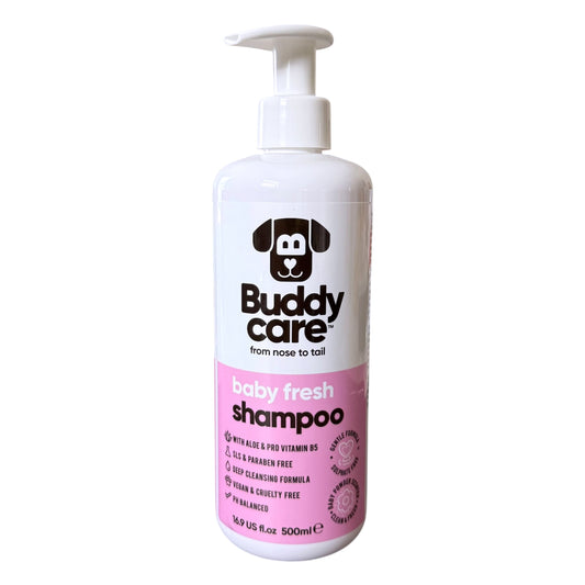 A 500ml bottle of Buddy Care Baby Fresh Shampoo for dogs, featuring a white pump dispenser and a label with a pink lower section and a black dog head logo.