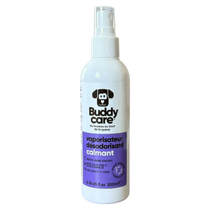 A white spray bottle of Buddy Care calming spray for dogs, featuring a purple label and a black dog logo, set against a plain white background.