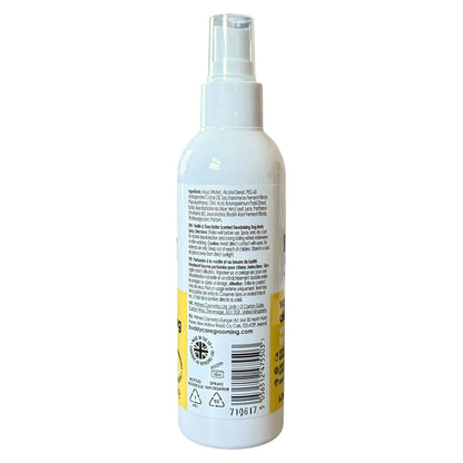 A white plastic spray bottle shown from the back, featuring a clear spray nozzle and a yellow label with black text and a barcode.