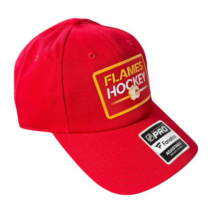 A red Calgary Flames baseball cap featuring a yellow and white 'FLAMES HOCKEY' patch on the front and a black and white NHL Pro Analytics sticker on the brim, set against a plain white background.