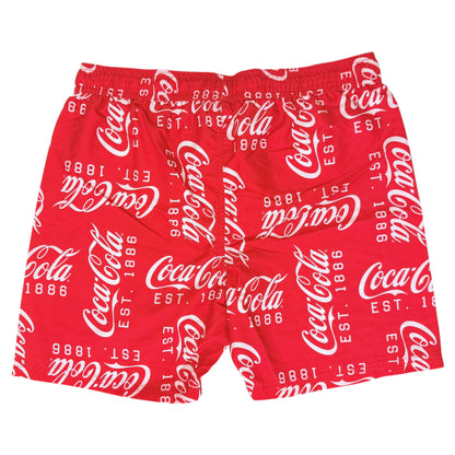 Red swim trunks with an all-over white Coca-Cola logo and script print, shown flat against a white background.