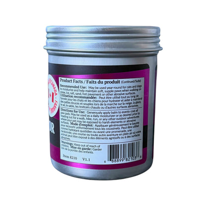 A jar of dr. maggie paw balm with a silver metal screw cap and a dark gray body. The side of the jar features a pink and black label with product facts, a barcode, and a red circular logo that reads 'Made in Canada'.