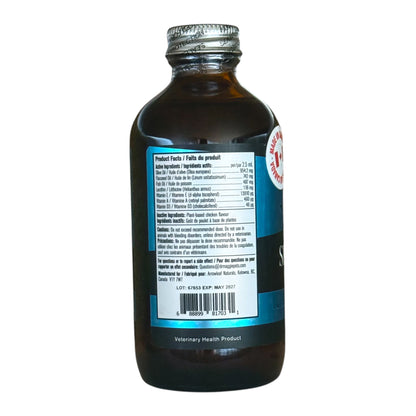 Side view of a dark amber bottle with a silver cap, showing a white nutrition facts label and a blue side label on a white background.