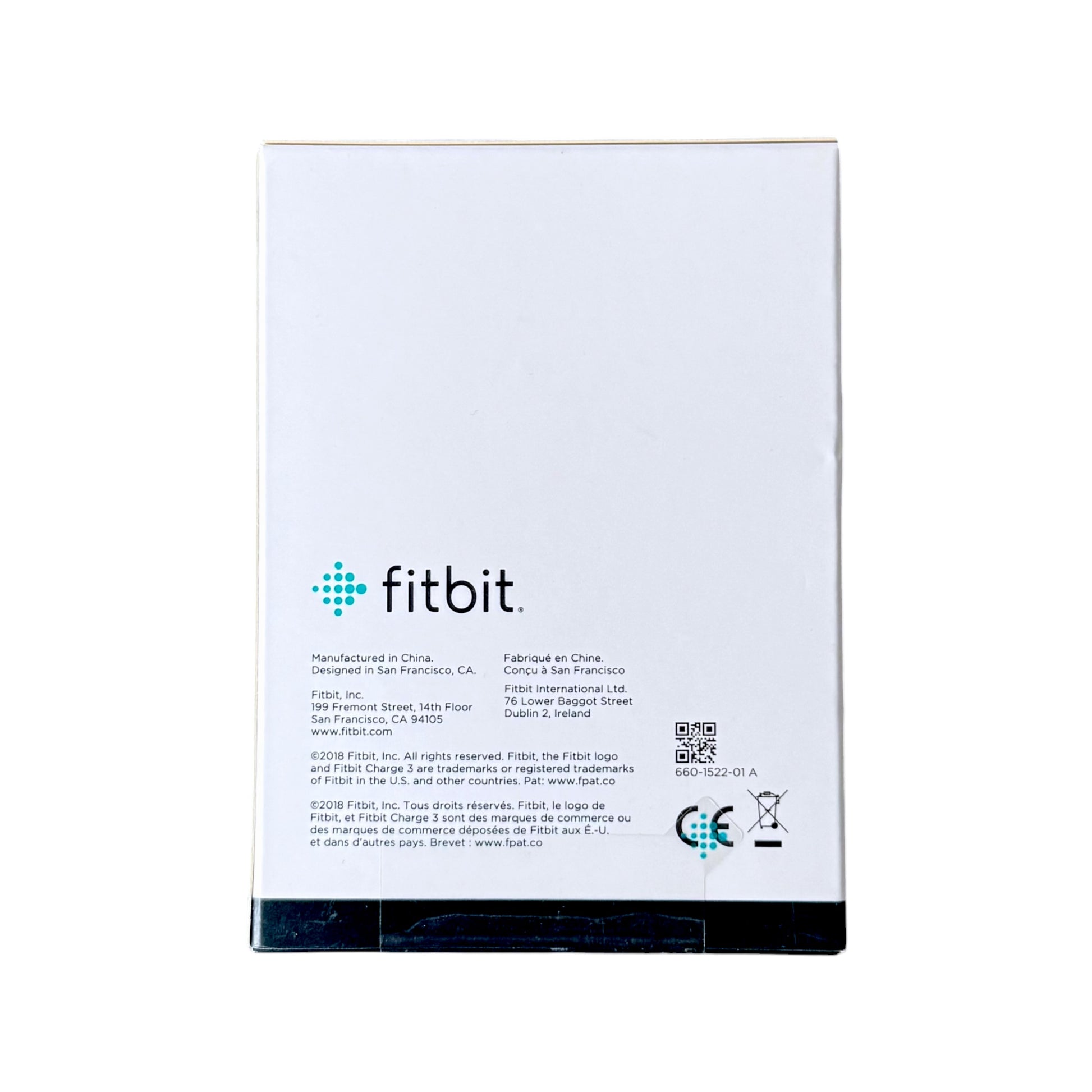 The back of a box showing the fitbit logo, manufacturing details, and a QR code on a white background.