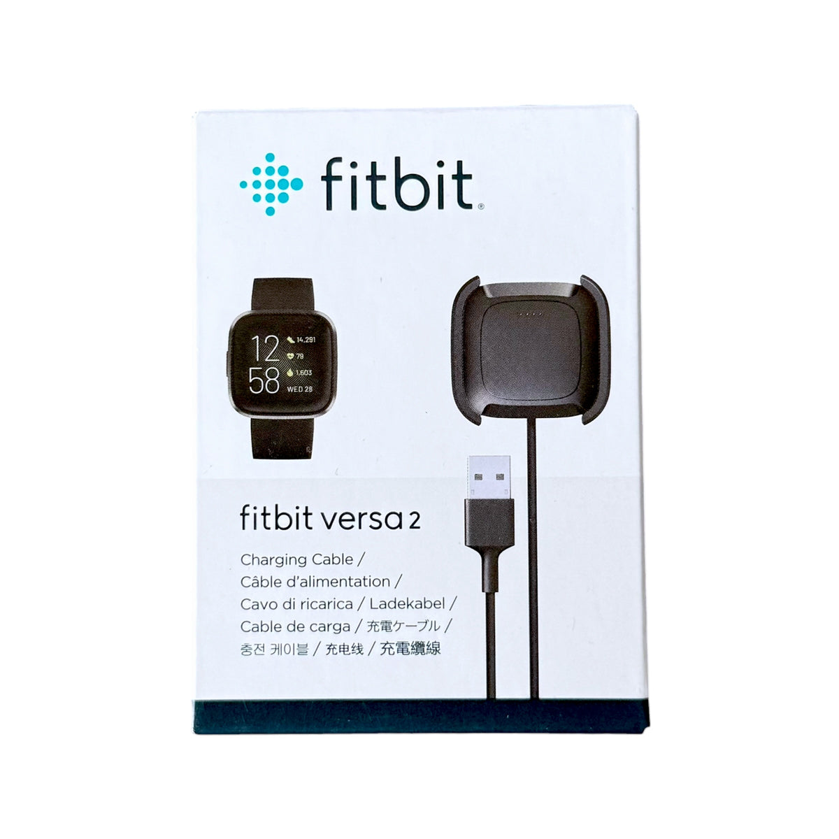 Fitbit Versa 2 charging cable and charging dock in its original white retail packaging, featuring the Fitbit logo and product illustrations.