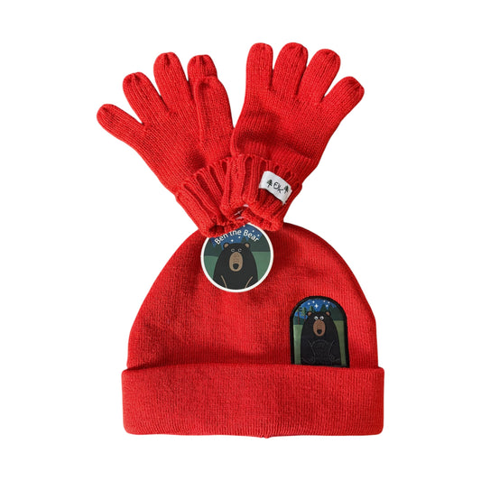A red knit FlapJackKids beanie and matching red knit gloves set, featuring a circular 'Brave the Bear' tag and a bear patch on the beanie, photographed on a white background.