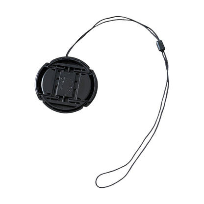 Black camera lens cap with a strap on a white background