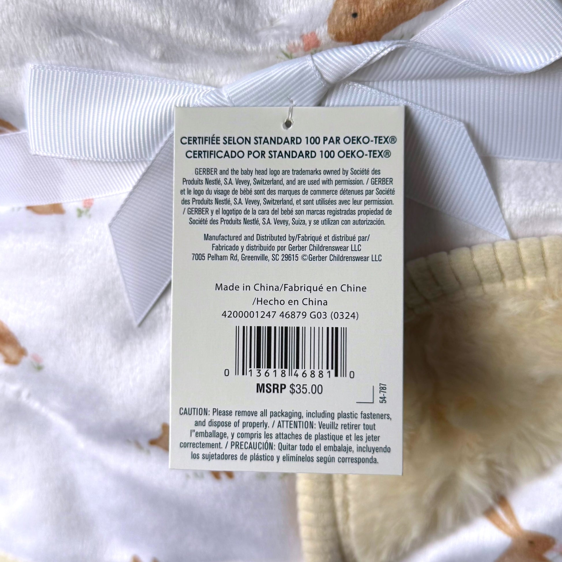 A close-up of a sale tag for a Gerber Childrenswear Plush Bunny Blanket