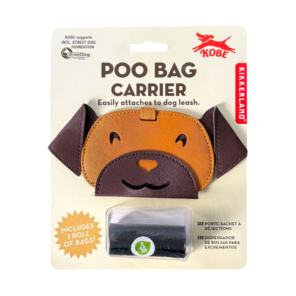 Kobe Kikkerland Poo Bag Carrier dog leash accessory in retail packaging, featuring a brown and tan dog-face shaped holder with a clear plastic dispenser window containing black pull-string bags.