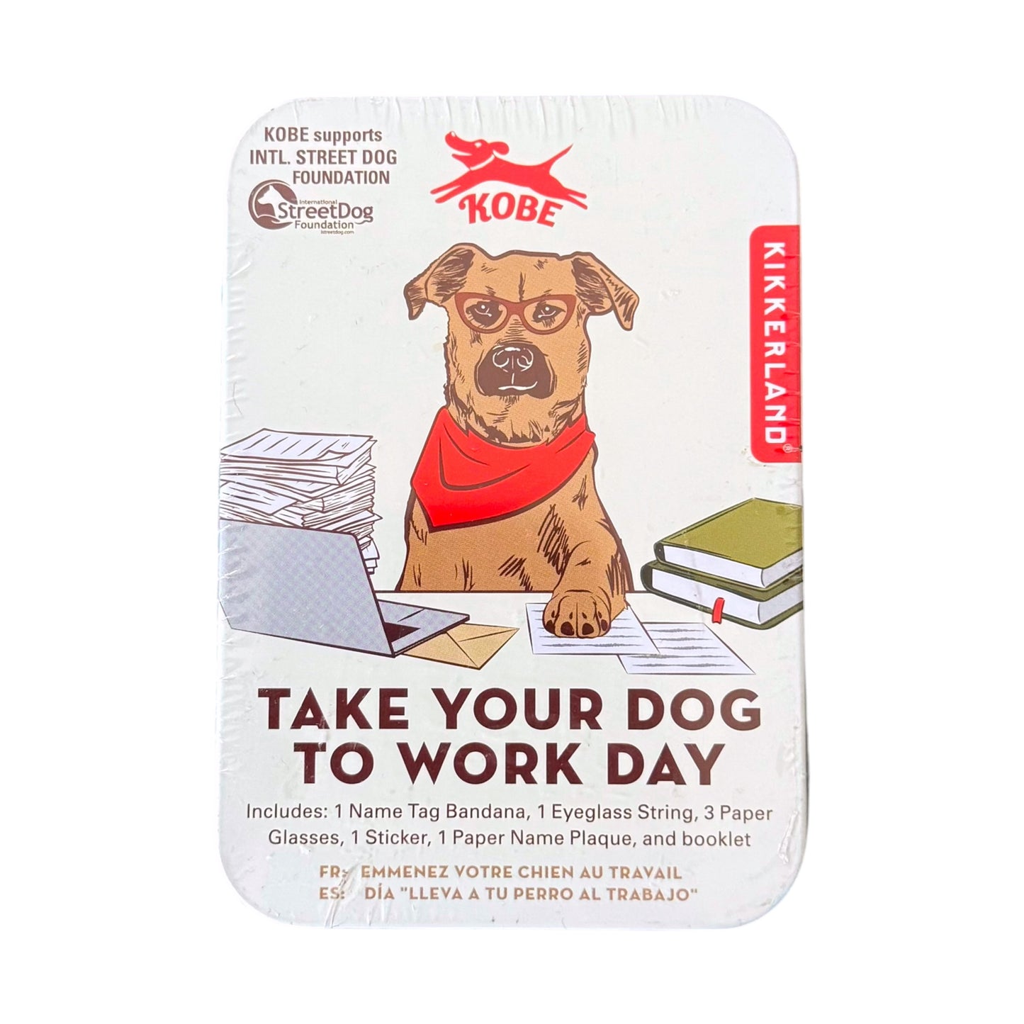 A packaged novelty gift set titled "Take Your Dog to Work Day" by Kikkerland, featuring an illustrated dog wearing a red bandana with office-themed items like a laptop, papers, and books on a white background.