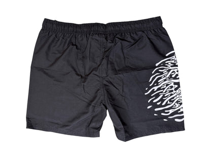 Photo shows a black pair of Liquid Death Men's Swim Shorts with retail tags attached. Shown on a white background.