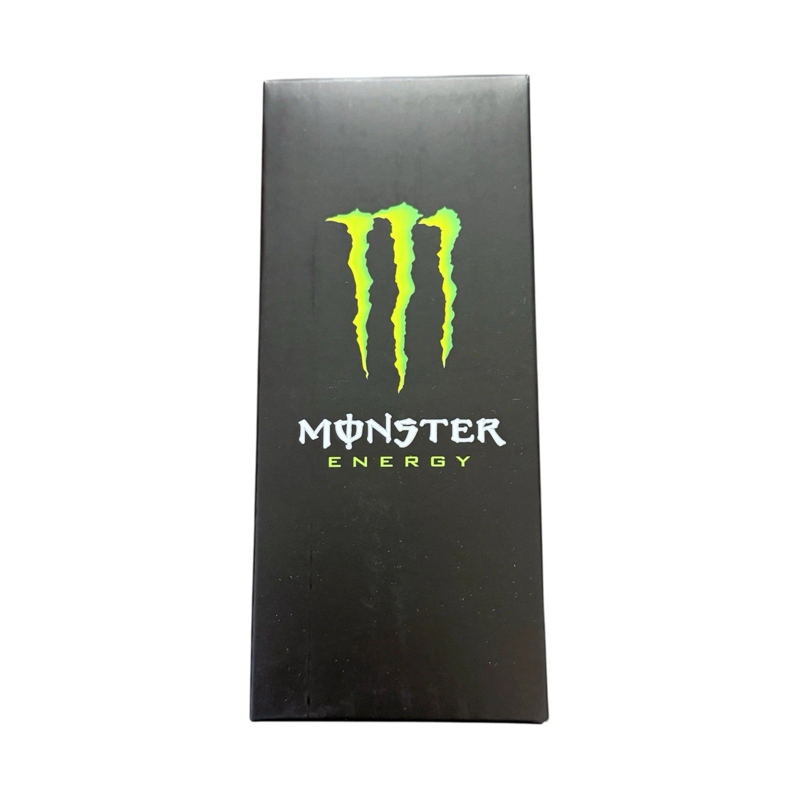 A tall, narrow black box featuring the bright green Monster Energy claw logo and white and green text on the front, centered against a plain white background.