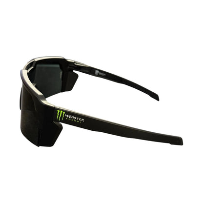 Black wrap-around sunglasses with a Monster Energy logo on the temple, shown against a plain white background.