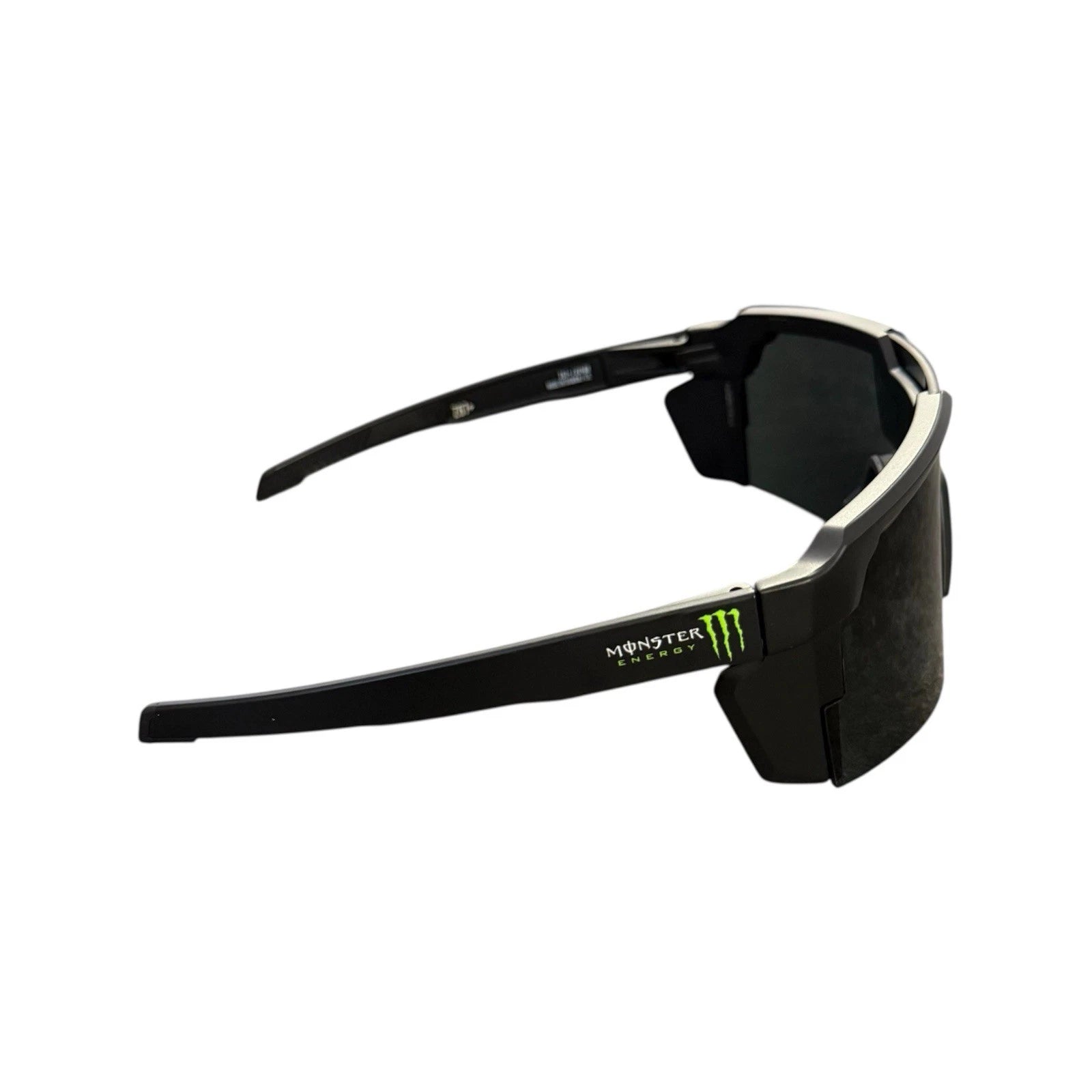 Black Monster Energy wrap-around sunglasses with dark lenses and a small green logo accent on the temple, shown against a plain white background.