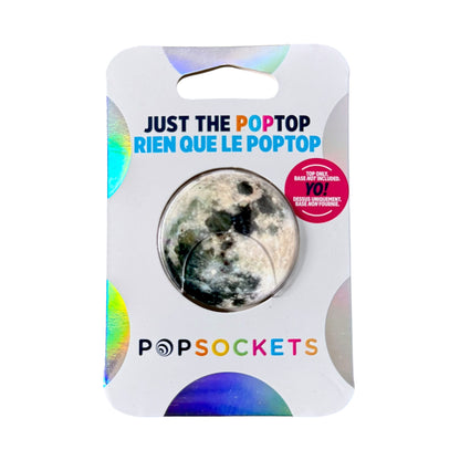 A Popsockets moon-shaped poptop in its retail packaging, featuring a circular cutout showing the textured moon design and a pink badge.