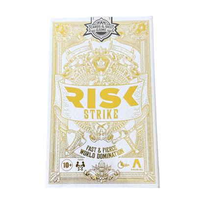 Risk Strike game box with gold and white design on a white background