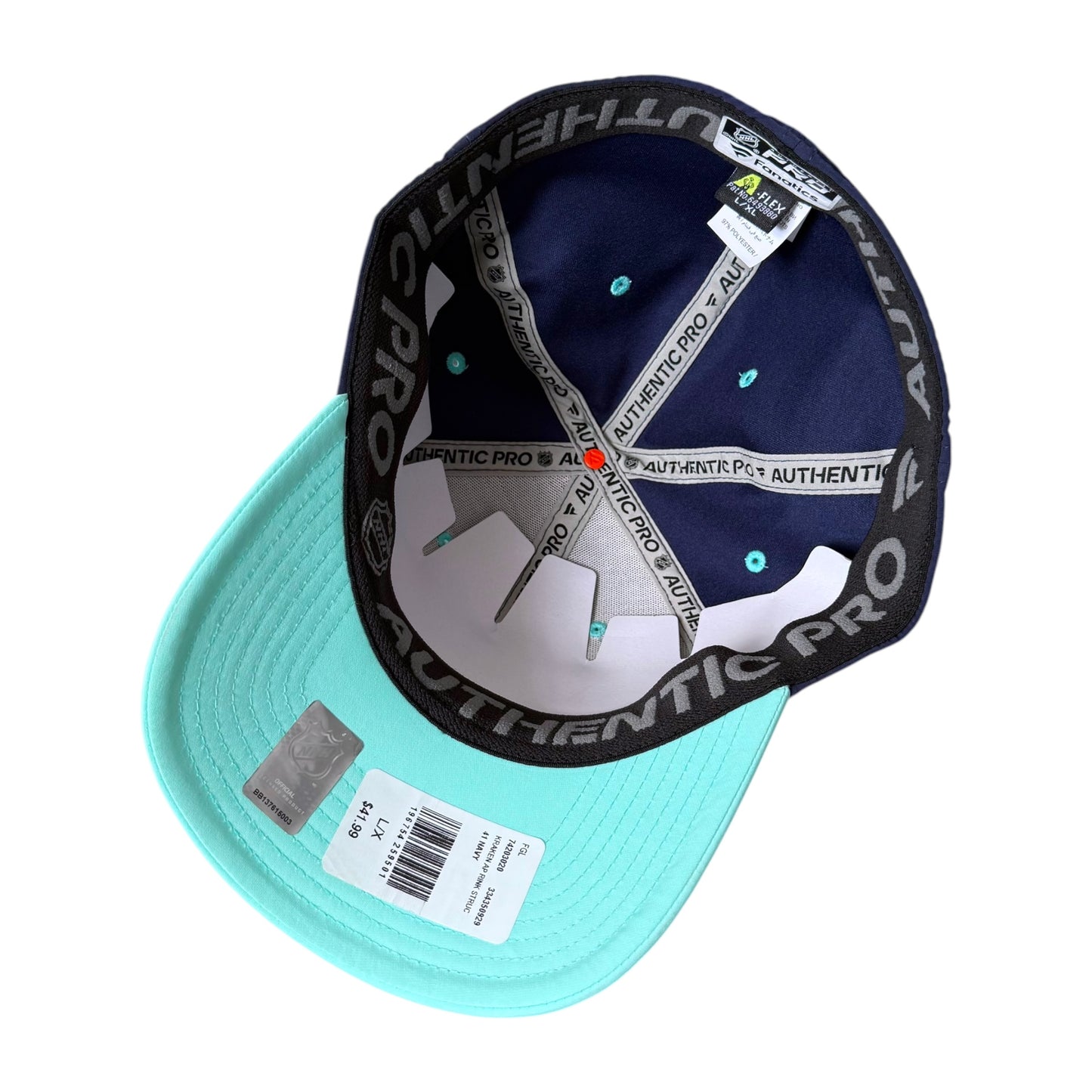 A turquoise and navy Authentic Pro baseball cap shown from an angled top view, displaying the interior branding, white elastic strap, and retail tags on a white background.