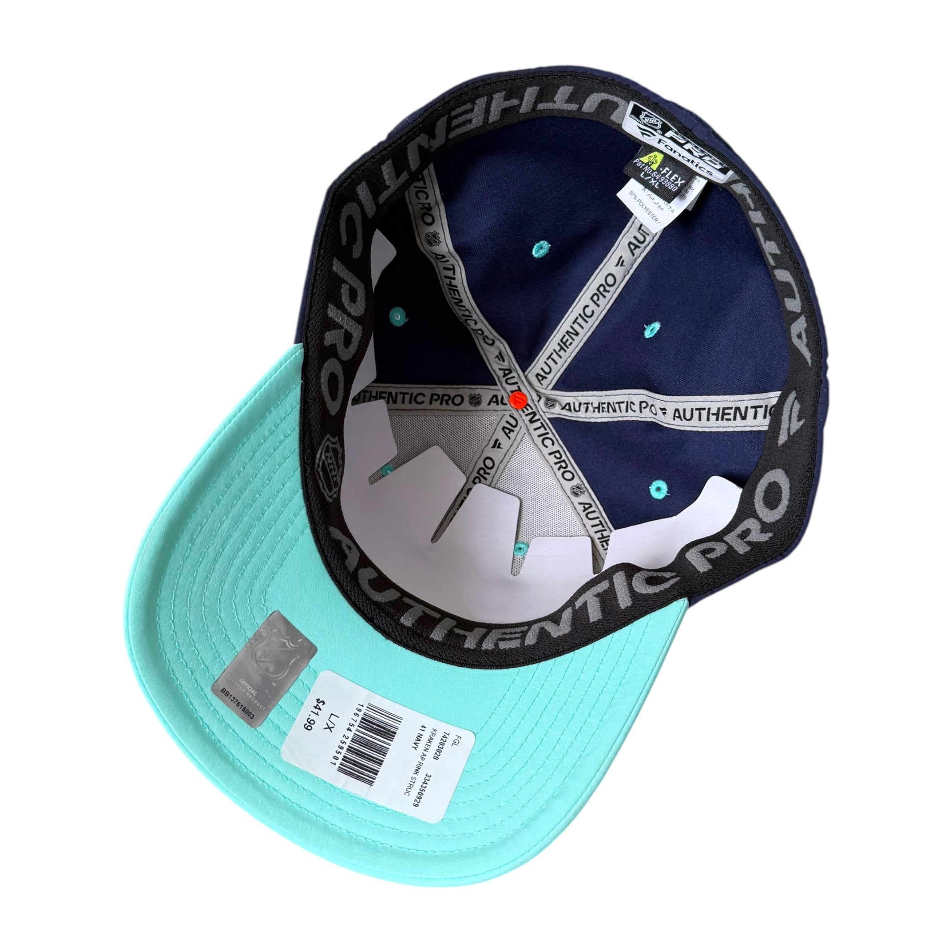 A turquoise and navy Authentic Pro baseball cap shown from an angled top view, displaying the interior branding, white elastic strap, and retail tags on a white background.