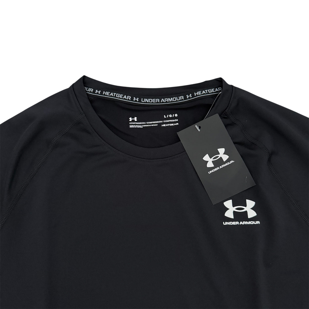 Black Under Armour shirt with a tag on a white background