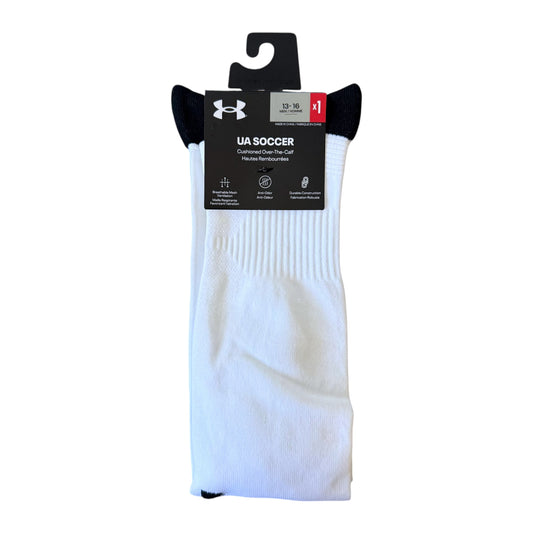 A pair of white UA Soccer crew socks with black heels and toes, packaged in a black retail hanging sleeve with the Under Armour logo.