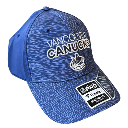 A blue heathered Vancouver Canucks baseball cap with white and black embroidered team text and logo on the front, plus a visible Fanicks Pro Stretch Fit sticker on the brim, shown on a plain white background.
