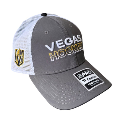 A gray and white Fanatics Vegas Golden Knights Hockey trucker hat with a gold and white Vegas shield logo on the side, 'VEGAS HOCKEY' embroidered on the front, and a Pro Factory adjustable strap patch on the brim.