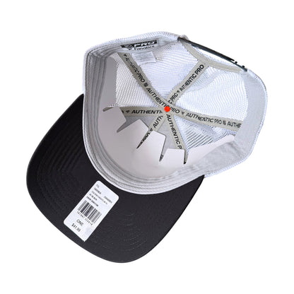 A black and white Authentic Pro trucker cap shown from an overhead angle, displaying the white mesh back, black visor, and interior branding.