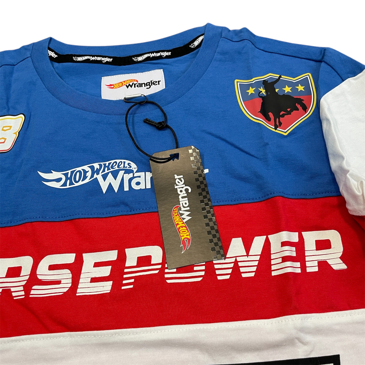 A long-sleeve men's shirt with color blocks in blue, white, and red, featuring the Wrangler and Hot Wheels brands.