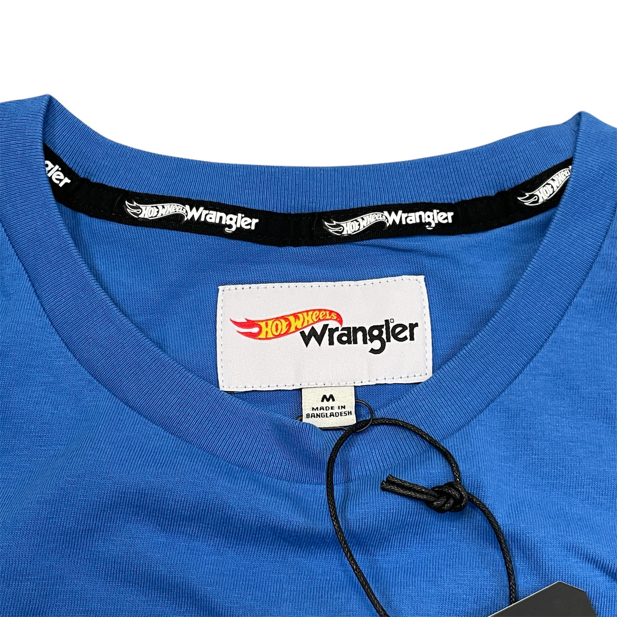 A long-sleeve men's shirt with color blocks in blue, white, and red, featuring the Wrangler and Hot Wheels brands.