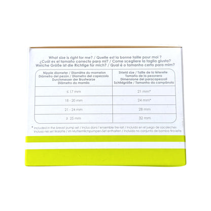 The back of a breast shield packaging box, showing a size guide table in English, Spanish, and German with a bright yellow-green band at the bottom, photographed on a white background.
