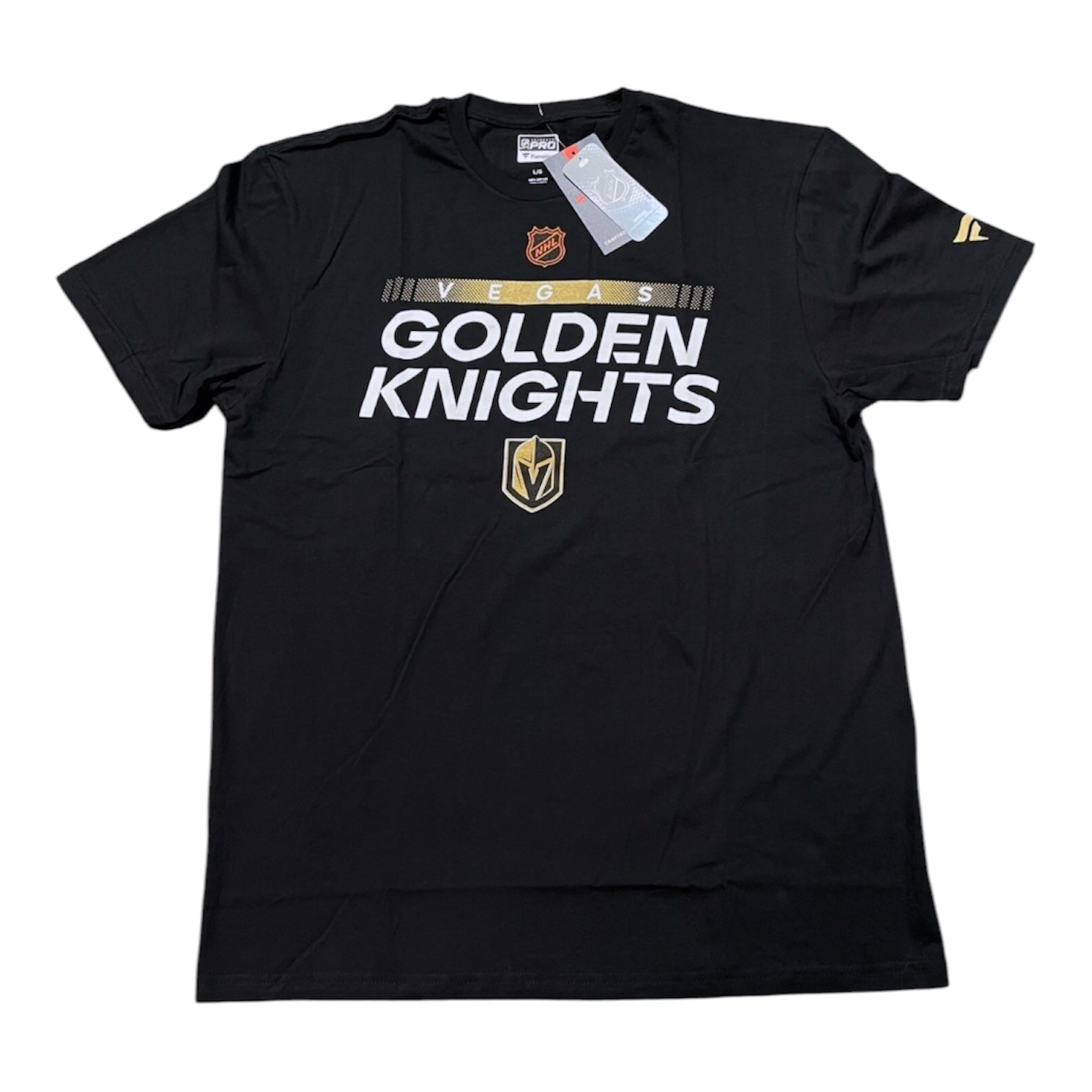 A black short-sleeve t-shirt with 'VERS GOLDEN KNIGHTS' printed in white across the chest, featuring the Vegas Golden Knights team logo in gold and white. The shirt is laid flat on a white background with its retail tags still attached.