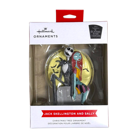 Hallmark Jack Skellington and Sally Christmas tree ornament in its box, with the couple seated in front of a yellow moon and bats.