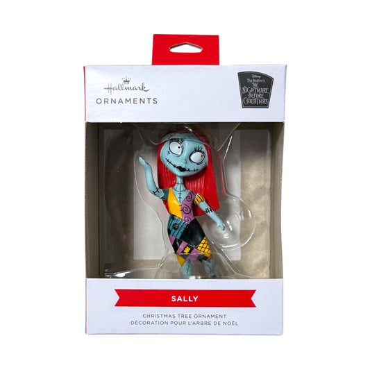 Hallmark Sally Christmas tree ornament from The Nightmare Before Christmas, wearing a colourful patchwork dress in its retail box.