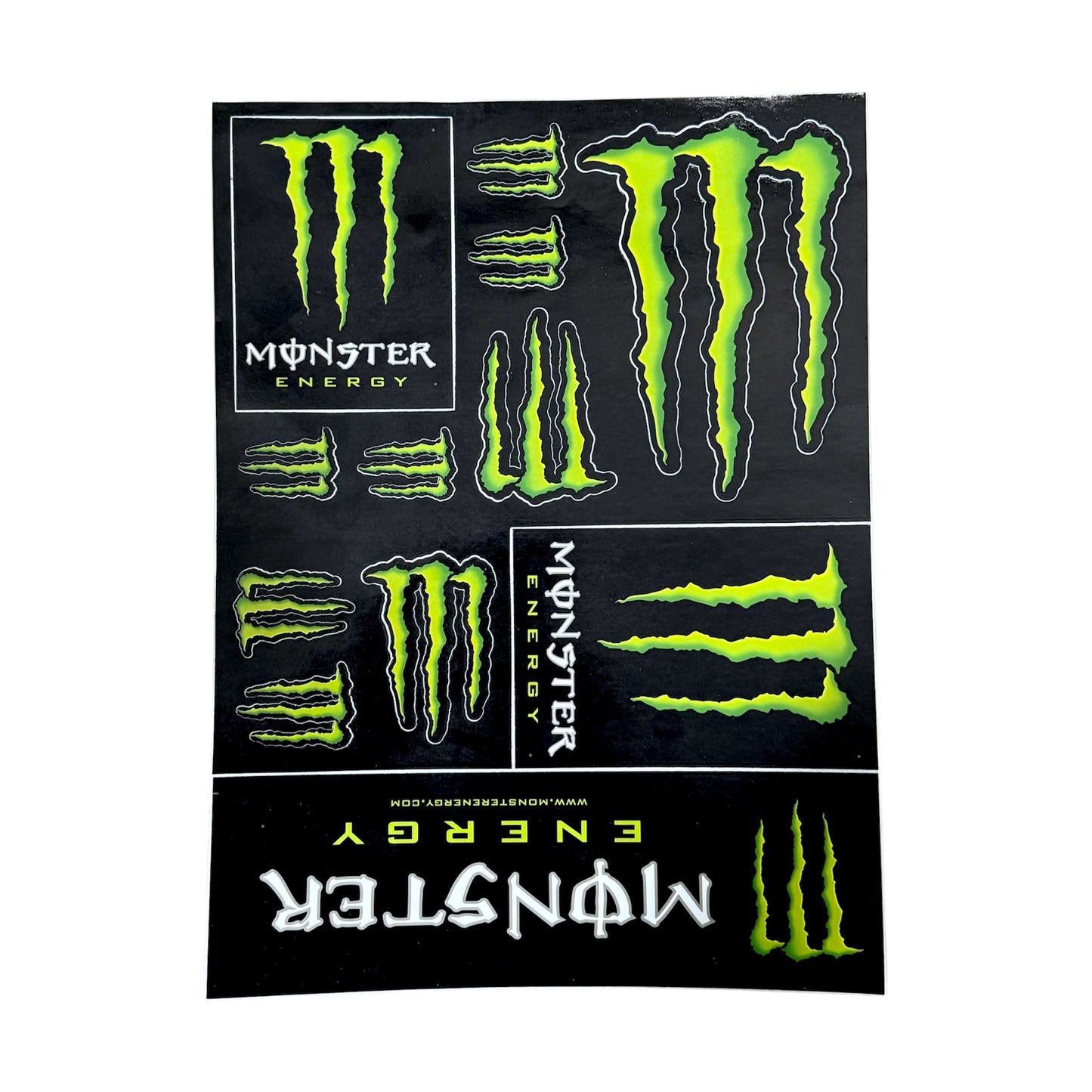 Monster Energy drink logo vinyl sticker sheets. green logos with text. sticker sheet shown on a white background