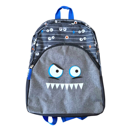 A children's backpack with a gray monster face on the front, featuring blue straps and a dark patterned top section with cartoon eyes and lightning bolts.
