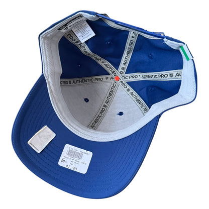 A Vancouver Canucks royal blue snapback cap shown from an overhead angle, revealing a white and gray Authentic Pro interior with branded elastic bands and retail tags on the brim.